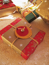 Concentric paper circles and a bead knotted with raffia act as both bow and tag.